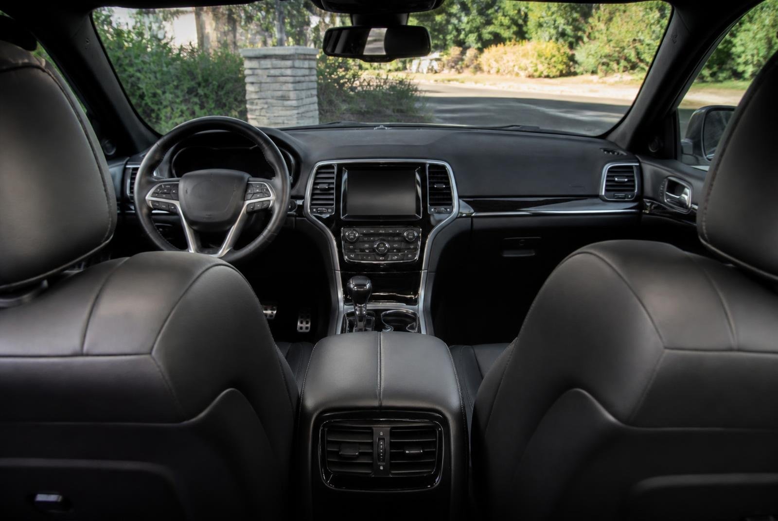 Detailed black leather cabin with spotless dash, console and carpets